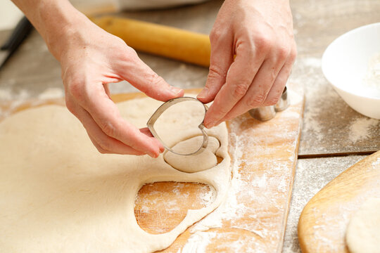 Making Heart Shaped Cookies for Loves Day. Close-up of male hands. Baking concept.