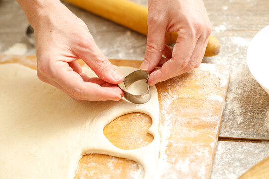 Making Heart Shaped Cookies for Loves Day. Close-up of male hands. Baking concept.