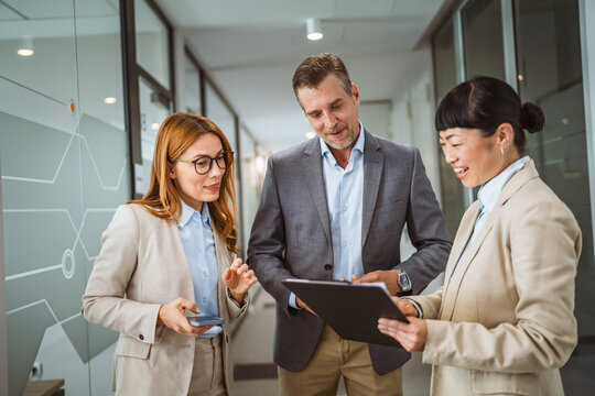 multicultural colleagues have informal meeting at company hallway