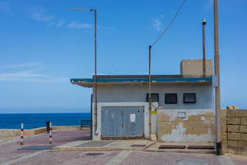 Marsaskala, Malta - 05.12.2025: An old abandoned service building in the middle of nowhere,...
