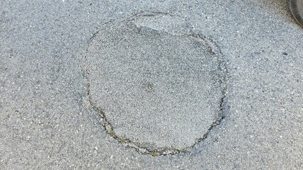 Circular Asphalt Patch on Road – Street Maintenance Close-Up