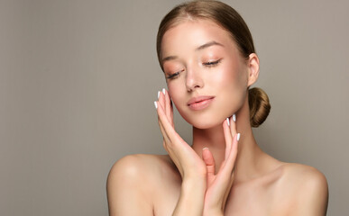 Beautiful young woman with clean fresh skin on face . Girl facial  treatment   . Cosmetology , beauty  and spa .