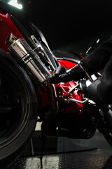 Exhaust Motorcycle System Maintenance. Mechanic tightening bolts on motorcycle chrome exhaust...