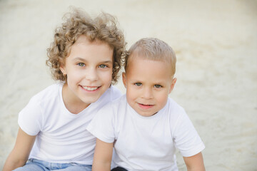 portrait of a boy and a girl, brother and sister. brother and sister looking at each other sweetly