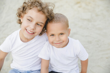 portrait of a boy and a girl, brother and sister. brother and sister looking at each other sweetly