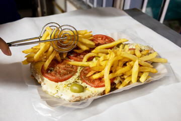 Conclusion of an Argentinean dish called Milanesa Napolitana where you can see the accompanying...