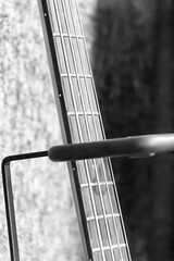 Close-up of an acoustic guitar neck with focus on the strings and fretboard details