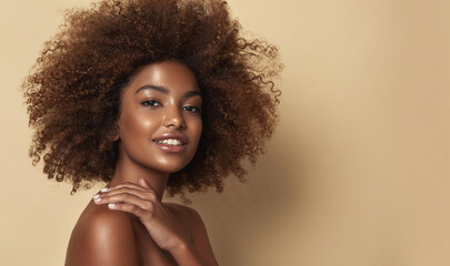 Beauty portrait of african american woman with clean healthy skin on beige background. Smiling dreamy beautiful afro haitstyle girl.Curly black hair