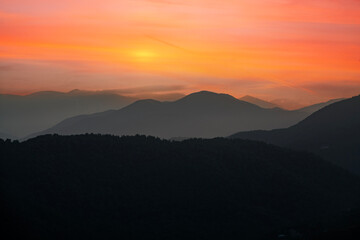Beautiful sunset over the silhouette  mountains.