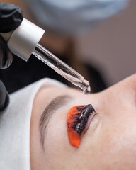 The process of professional lamination and tinting of eyelashes in the salon.