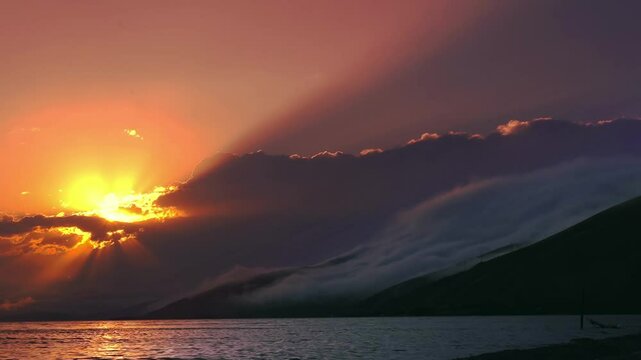 Beautiful sunset with clouds over the lake time lapse.