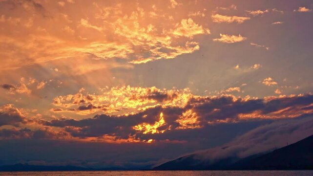 Beautiful sunset with clouds over the lake time lapse.