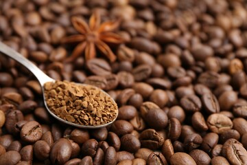 Spoon with granulated instant coffee and star anise on beans, closeup. Space for text