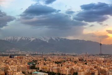 Beautiful cityscape sunset panorama of Tehran city, mountains and Milad tower in during colorful sunset in Iran