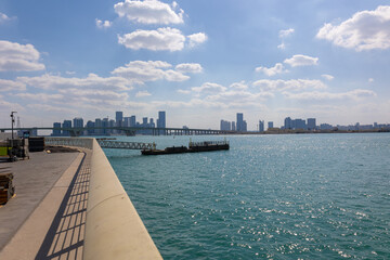 View of city with towers and skyscrapers from Saadiyat Island in Abu Dhabi, United Arab Emirates. View from water surface. High quality photo