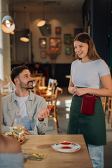 Waitress taking order from customer in restaurant