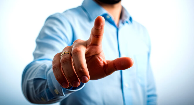 Man in light blue shirt pressing an invisible button or touchscreen, focusing on the point gesture.