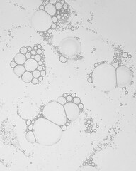 Cosmetic gel, serum transparent sample. Liquid cream with bubble texture. Gel texture of a cosmetic product. Clear liquid lotion for skin care.