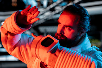 Close up of cautious astronaut guarding against alien threat emerging after disturbing its habitat....
