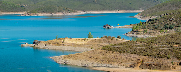 Lake surrounded by hills and arid landscape