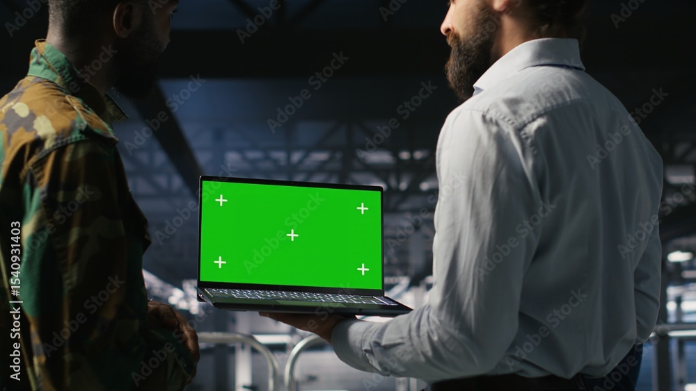 Poster army tech specialist in data center and coworkers using green screen laptop to troubleshoot military