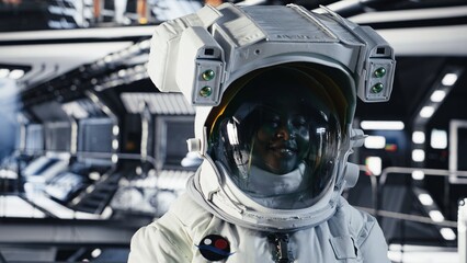 Portrait of joyful astronaut putting cosmic protection equipment on, doing human expansion in space. Radiant cosmonaut mapping unknown worlds during mankind survival expedition to Mars