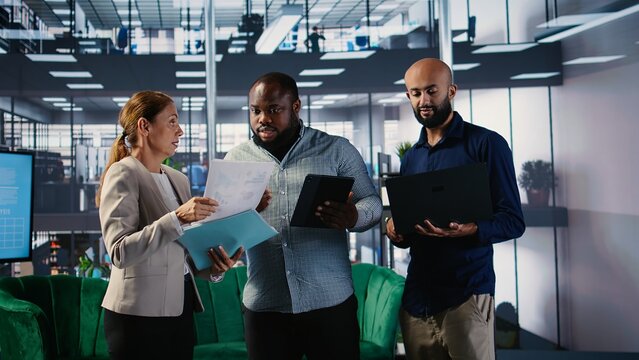 Multicultural corporate professionals with goal oriented mindset participating in meetings, global development. People with leadership skills uses research and business insights. Camera A.