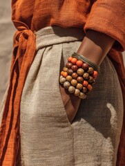 Woman's Hand with Beaded Bracelets and Textured Fabric
