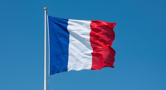 French flag waving proudly in the wind against a clear blue sky, symbol of national pride, patriotism, outdoor scene