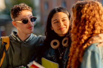 Group of cheerful multi ethnic students chatting together at university campus during a break...