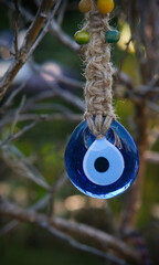 Cultural evil eye bead hanging on tree