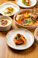 A selection of meticulously crafted gourmet dishes arranged elegantly on wooden table