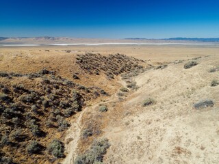 A lone hiker pauses to take in the view of Soda Lake in Carrizo Plain National Monument,...