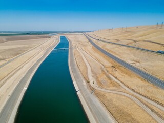 Aerial view of the California Aqueduct, a vital water source, flowing through arid landscape near a...