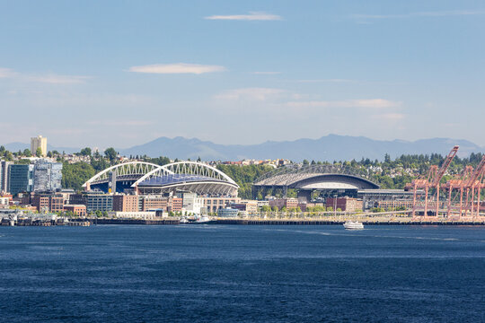 Seattle, WA, USA - May 30, 2025: A skyline view looking towards Seattle's Lumen Field and T-Mobile Arena, home to the cities professional football, baseball, and soccer teams.