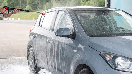 Vehicle cleaning. Automobile car wash soap. Foam spray water exterior detail.