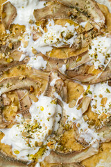 Satisfy your sweet cravings with a fresh dessert featuring crushed ripe bananas, creamy yogurt, and a sprinkling of nuts for texture. This enticing dish is perfect for any occasion