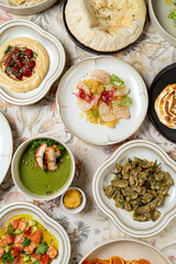 A captivating spread of Middle Eastern cuisine showcases colorful plates filled with hummus, fresh salads, grilled meats, and desserts, inviting enjoyment and celebration