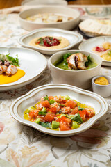 Bright colors fill the table with a tantalizing spread of Mediterranean dishes, showcasing fresh vegetables, flavorful dips, and succulent proteins, all presented beautifully