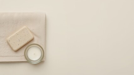 Minimal Spa Flat Lay with Towel, Natural Soap, and Candle on Cream Background
