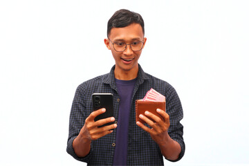 An Asian man holding a cellphone and a wallet filled with money with a happy expression