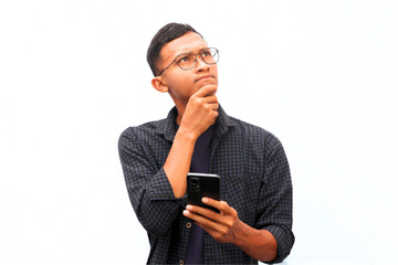 An Asian man holds a cellphone with a thinking expression.