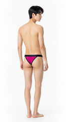 Fototapeta premium Asian male model showcases bold magenta and black cut-out briefs on a white background, blending contemporary men’s fashion, style, and confidence in this modern underwear photoshoot.