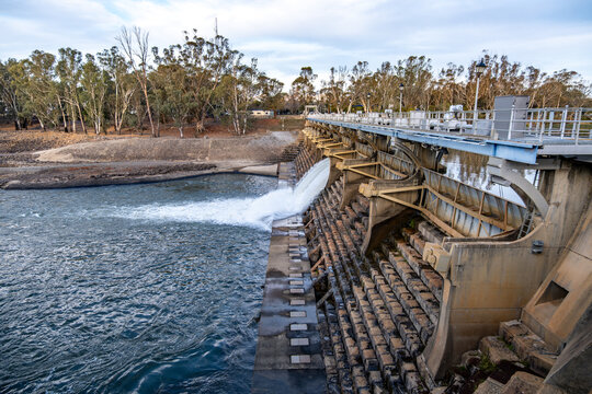 Goulburn Weir in Victoria, Australia with stepped spillway and flowing water.The historic irrigation structure is releasing water into the Goulburn River in winter. Agricultural irrigation in country.