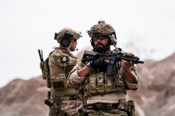 Fototapeta premium Special Forces Soldiers Armed and Ready During Tactical Training – Focused Military Men in Camouflage Uniform, Holding Assault Rifles, Outdoor Combat Operation in Desert Terrain