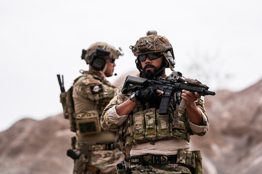 Special Forces Soldiers Armed and Ready During Tactical Training – Focused Military Men in Camouflage Uniform, Holding Assault Rifles, Outdoor Combat Operation in Desert Terrain