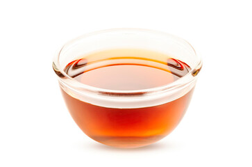 Glass bowl of fresh honey isolated on white background.
