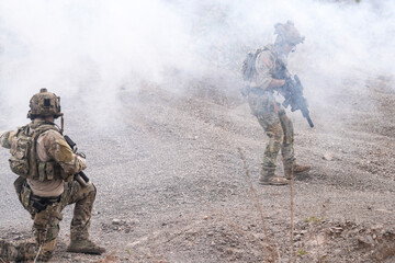 Special Forces Soldier Standing in Smoke During Tactical Operation – Full Combat Gear with Rifle...