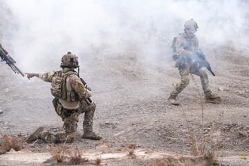 Special Forces Soldier Standing in Smoke During Tactical Operation – Full Combat Gear with Rifle...