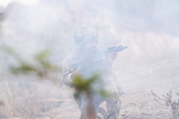Special Forces Soldier Standing in Smoke During Tactical Operation – Full Combat Gear with Rifle...
